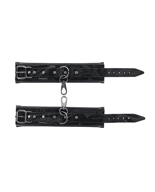 Black wrist cuff bands with buckle straps, metal rings, and perforated adjustment holes.