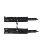 Black wrist cuff bands with buckle straps, metal rings, and perforated adjustment holes.
