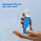 Blue intimate lubricant bottle held in hand, white flip-top cap