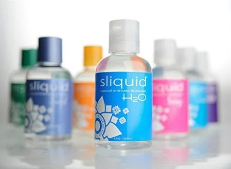 Assorted intimate lubricant bottles with blue and pink labels, plastic squeeze bottles