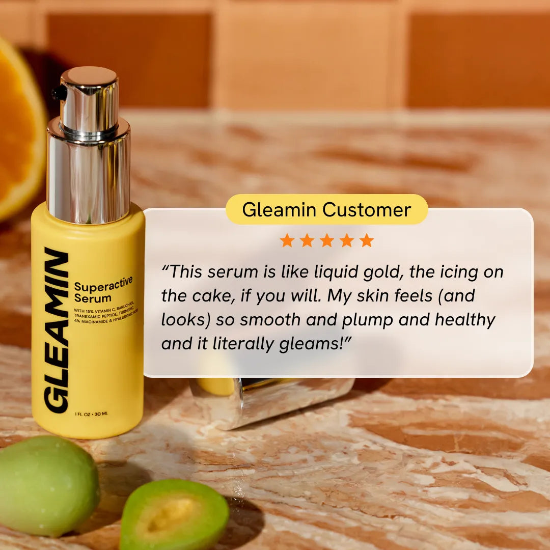 Superactive Serum yellow bottle with silver pump beside skincare items