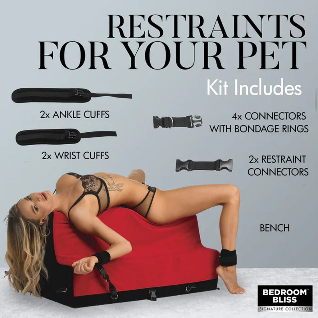Red and black bondage bench with ankle and wrist cuffs attached