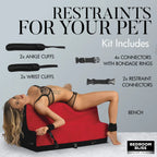 Red and black bondage bench with ankle and wrist cuffs attached