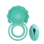Teal silicone bath toy with textured flower pad, two ring handles and oval remote