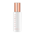 Cleansing mist bottle with rose-gold cap, white label, and spray nozzle