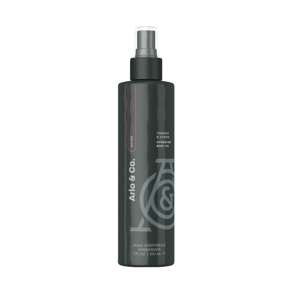 Hydrating body oil bottle with black pump, dark bottle with gray logo and text.