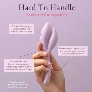 Purple double-ended silicone massager held in hand, two flexible tips