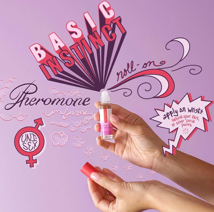 Basic Instinct sex attractant bottle in hand, red cap and dropper tip
