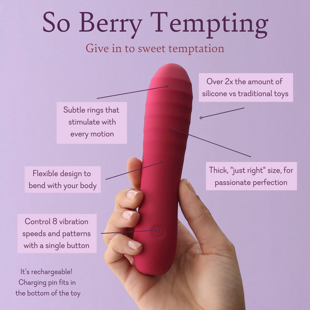 Berry-pink handheld silicone wand massager held between fingers