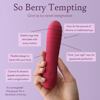 Berry-pink handheld silicone wand massager held between fingers