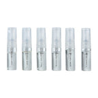 Row of clear fragrance travel spray bottles with printed labels and small caps