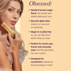 Beige solid fragrance stick held near the mouth and chin