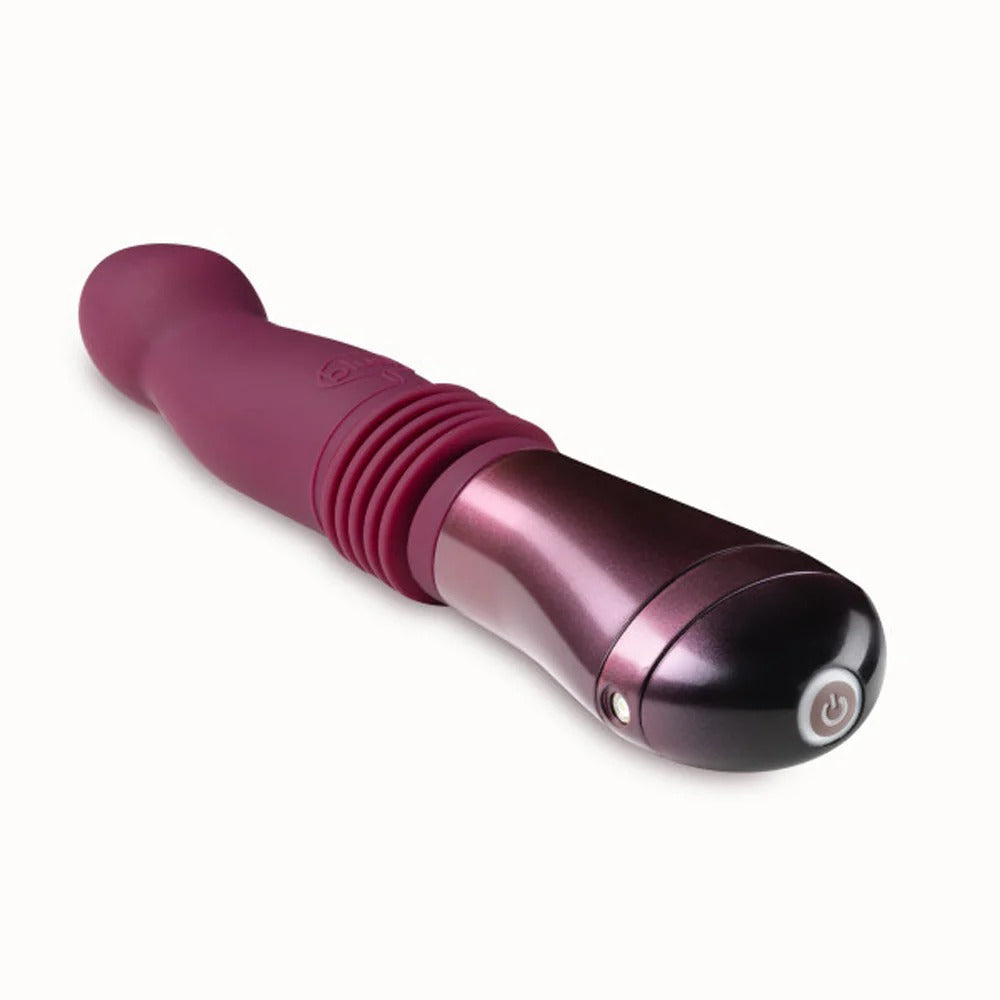Pink thrusting vibe with ribbed grip and glossy dark base, power button on handle.