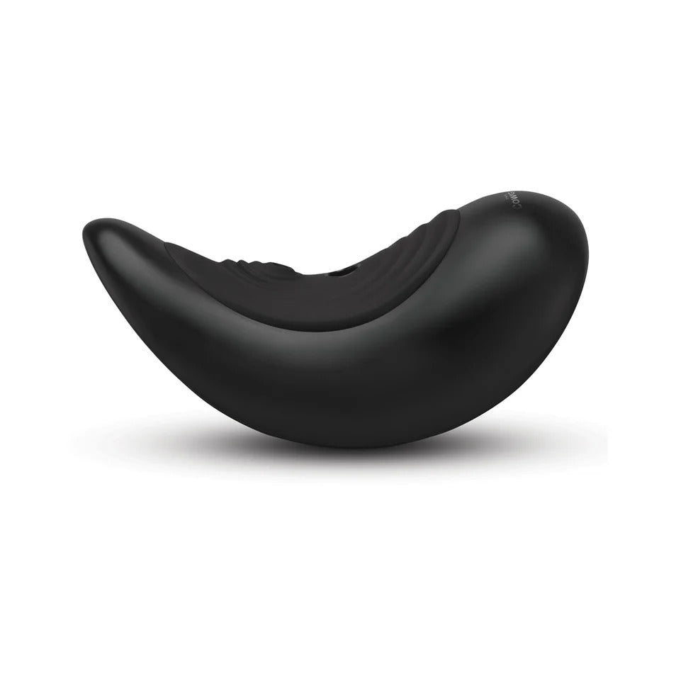 Black curved massage saddle with ribbed texture and contoured backrest