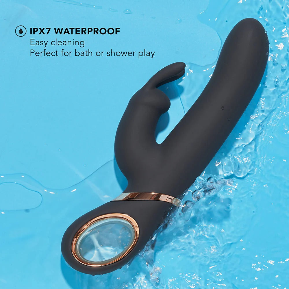 Black G-spot vibrator with rose-gold ring partially splashed in water