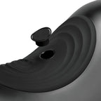 Black saddle massager close-up with circular control and side port