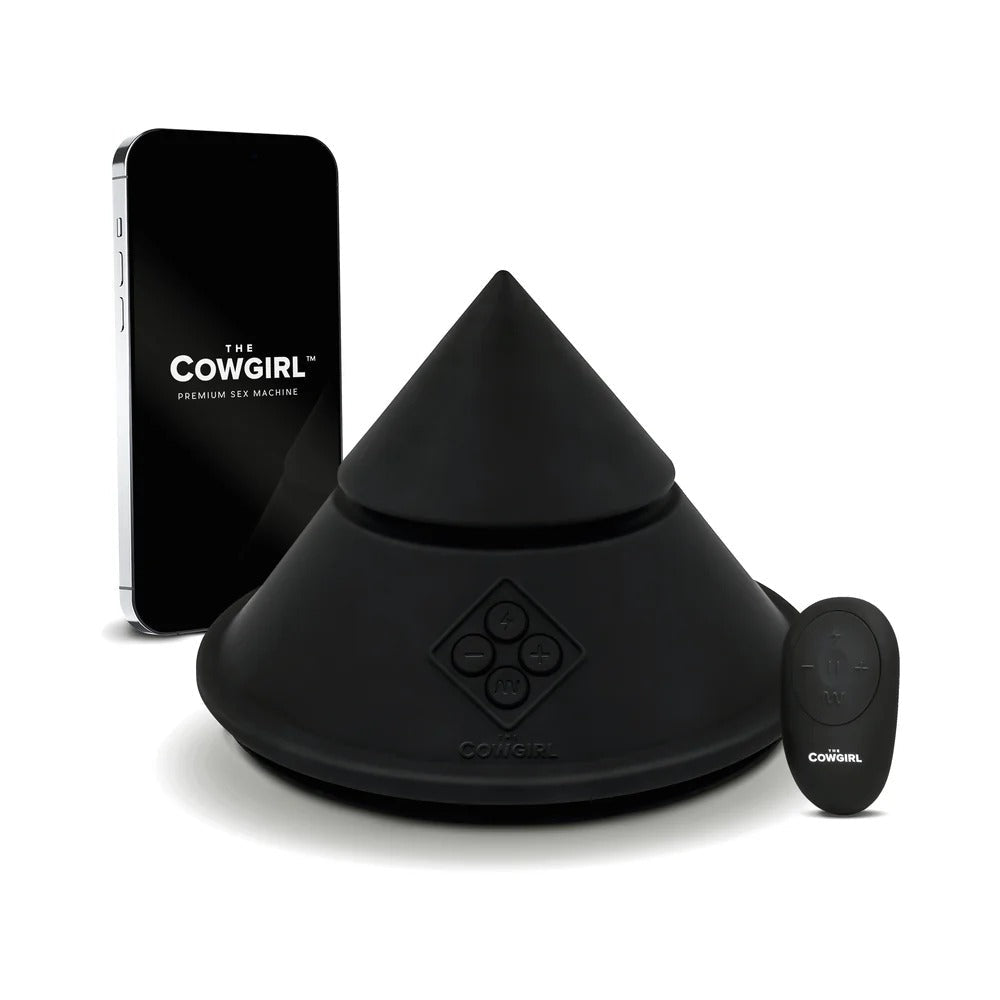 Black cone-shaped sex massager with base and handheld remote, countertop view