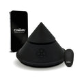 Black cone-shaped sex massager with base and handheld remote, countertop view