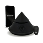 Black cone-shaped sex massager with base and handheld remote, countertop view