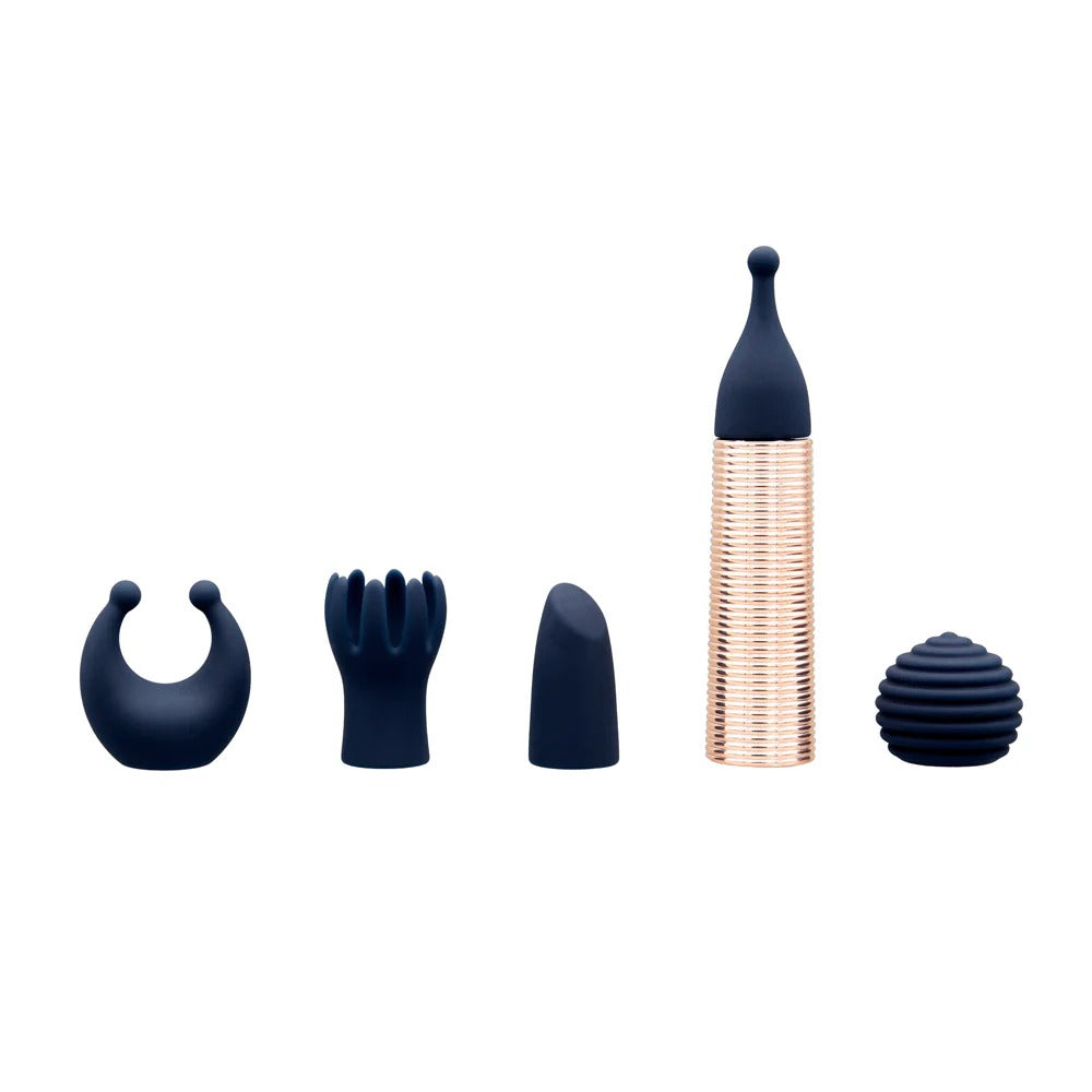 Mini massager set with rose-gold ribbed handle and navy attachments arranged around it