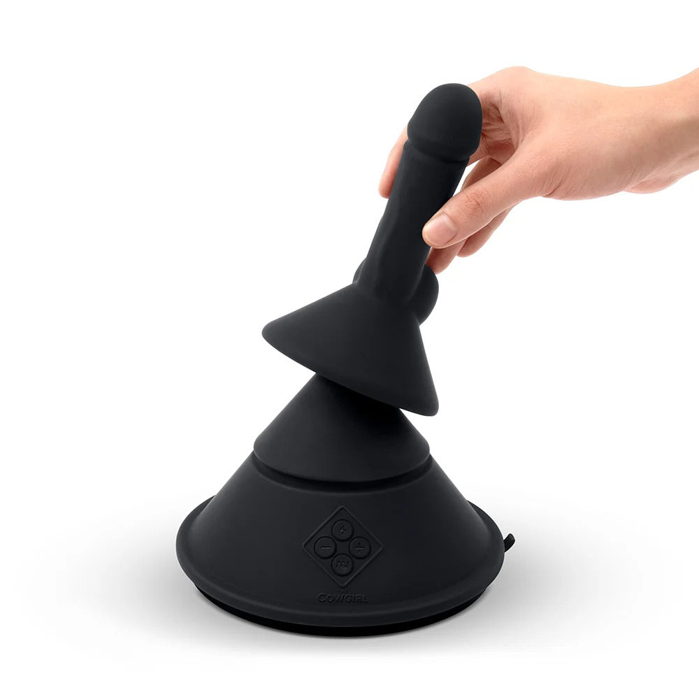 Black cone-shaped sex massager held by an adult hand, upright top visible
