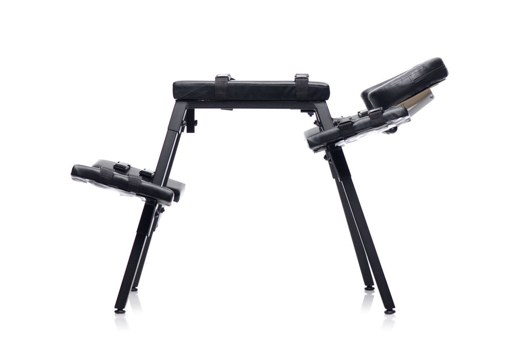 Black padded sex bench with angled headrest and side restraint pads