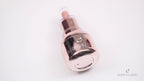 Rose gold oil bottle with heart logo and dropper