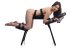 Black padded sex bench with leg restraint straps and arm support