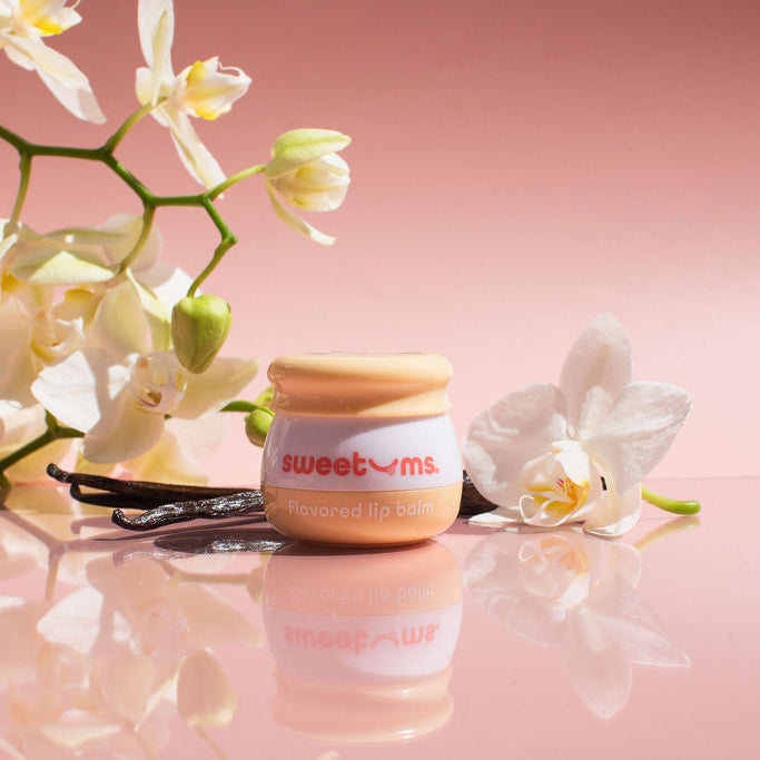 Sweetums vanilla flavored lip balm jar with vanilla flower and pods