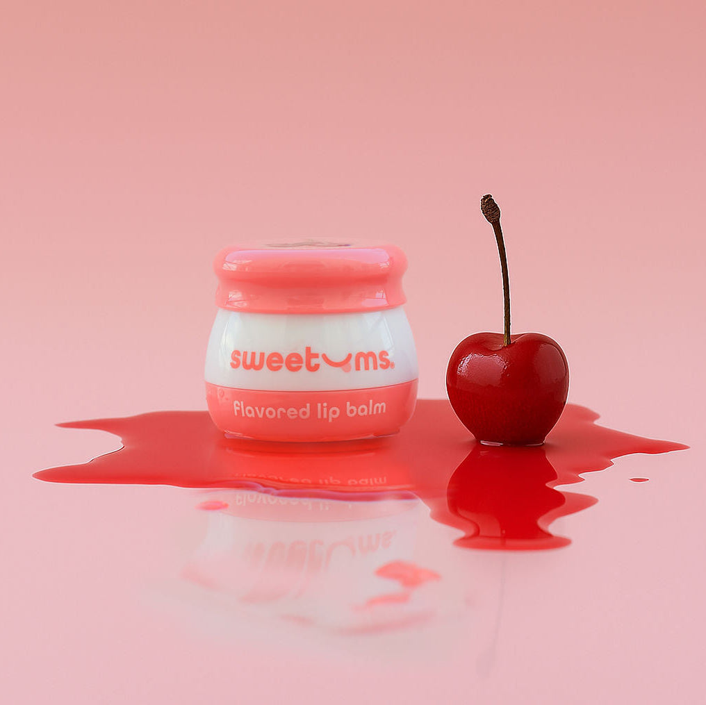 Cherry flavored lip balm jar with pink lid and cherry-shaped applicator
