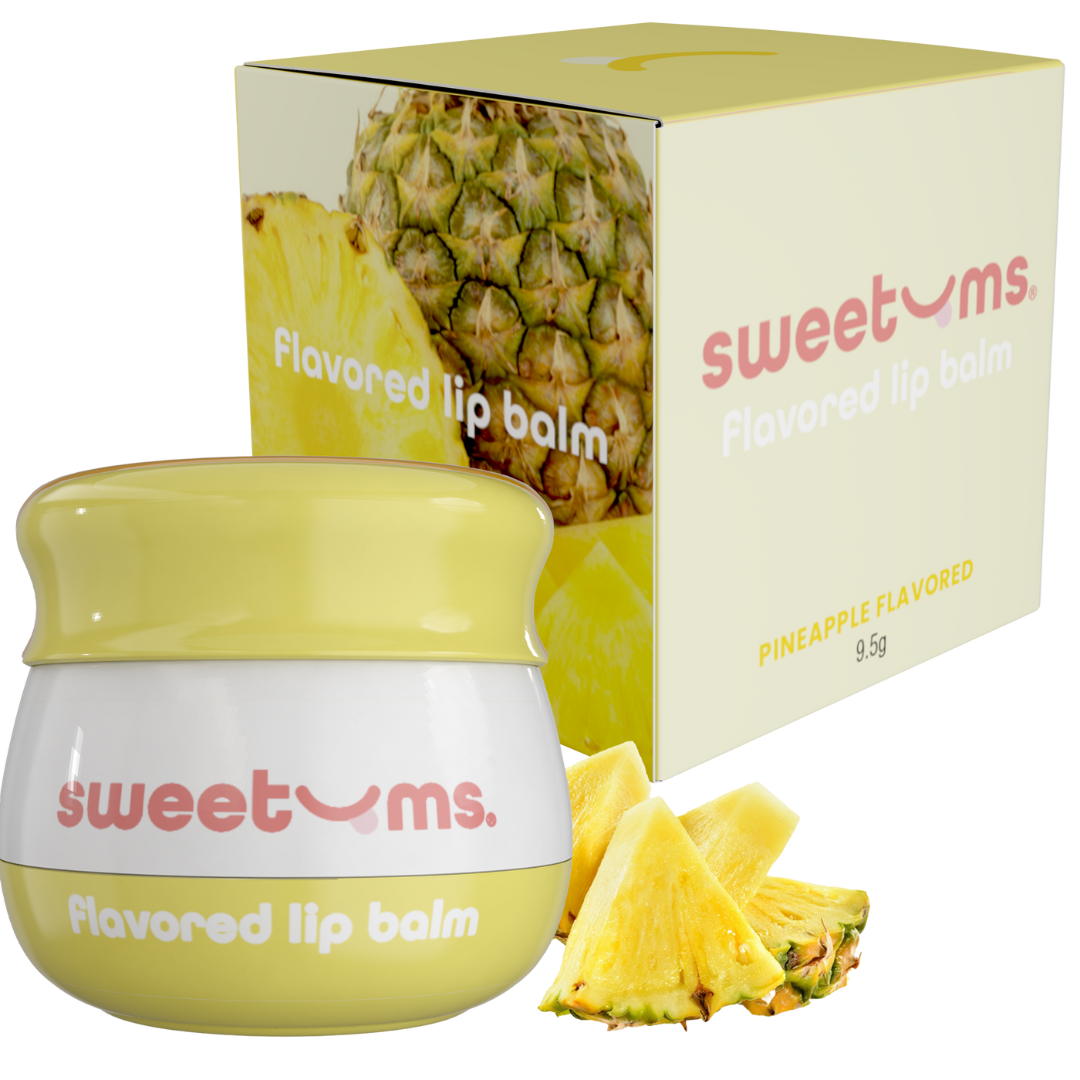 Pineapple-flavored lip balm jar, yellow balm, with Sweetums box and pineapple pieces